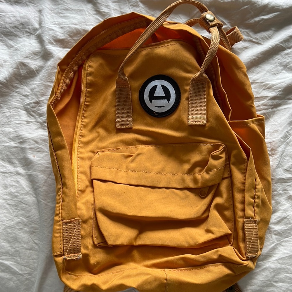 Canadian brand blue notes mustard yellow backpack new used maybe 2xs.